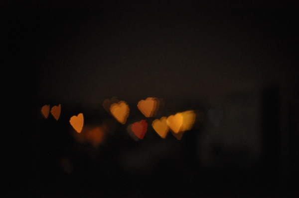 The same out-of-focus lights, now forming heart shapes thanks to the carved card in front of the lens